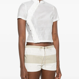 White tops worn by a person, showing the white tops' fit