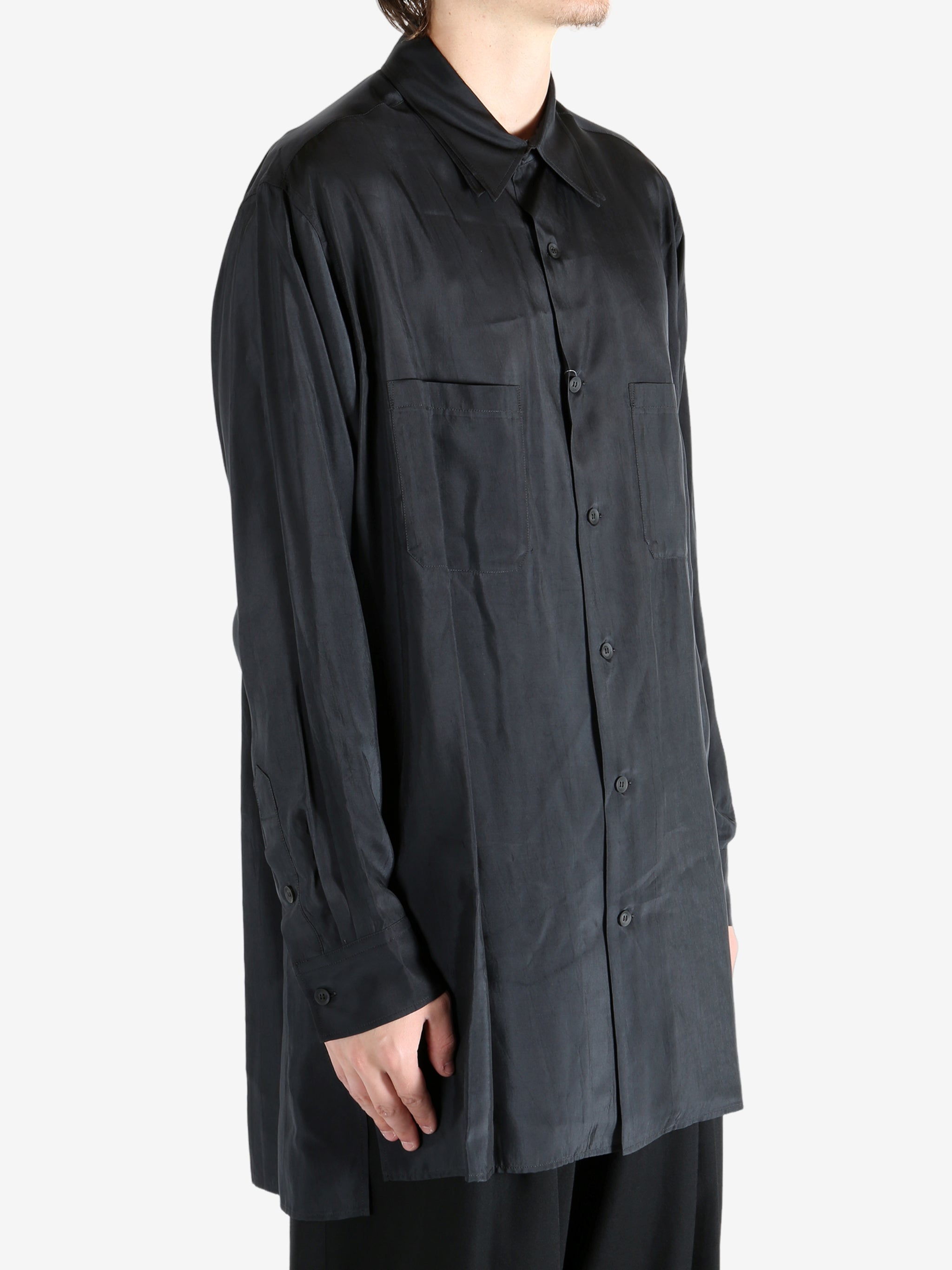 Black shirt worn by a person, showing the shirt's fit