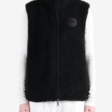 Black top worn by a person, showing the top fit
