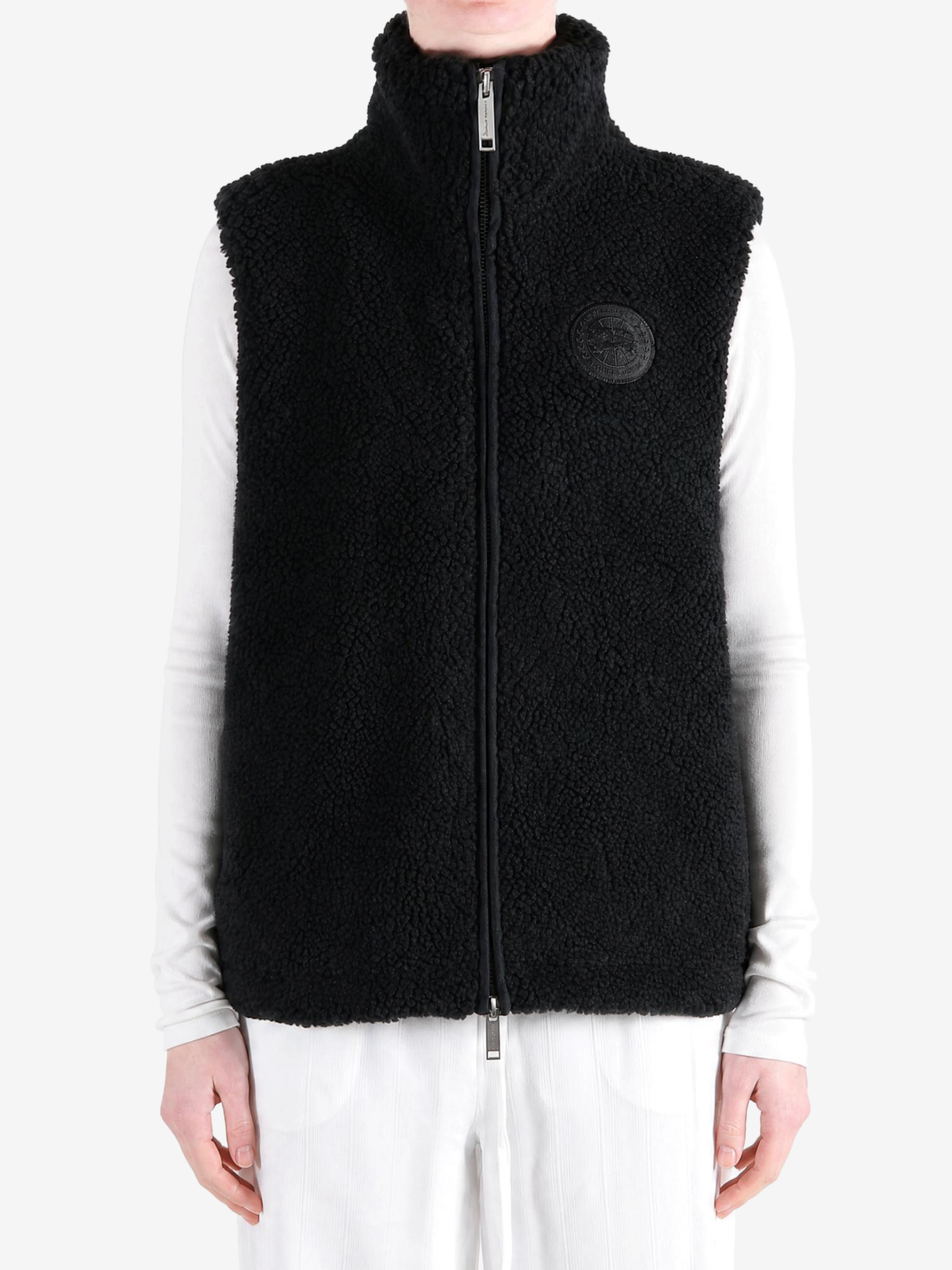 Black top worn by a person, showing the top fit