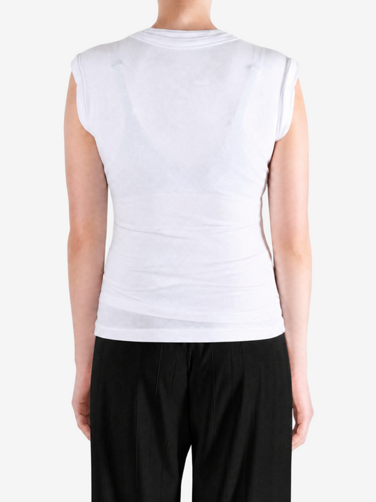 White top worn by a person, showing the top fit