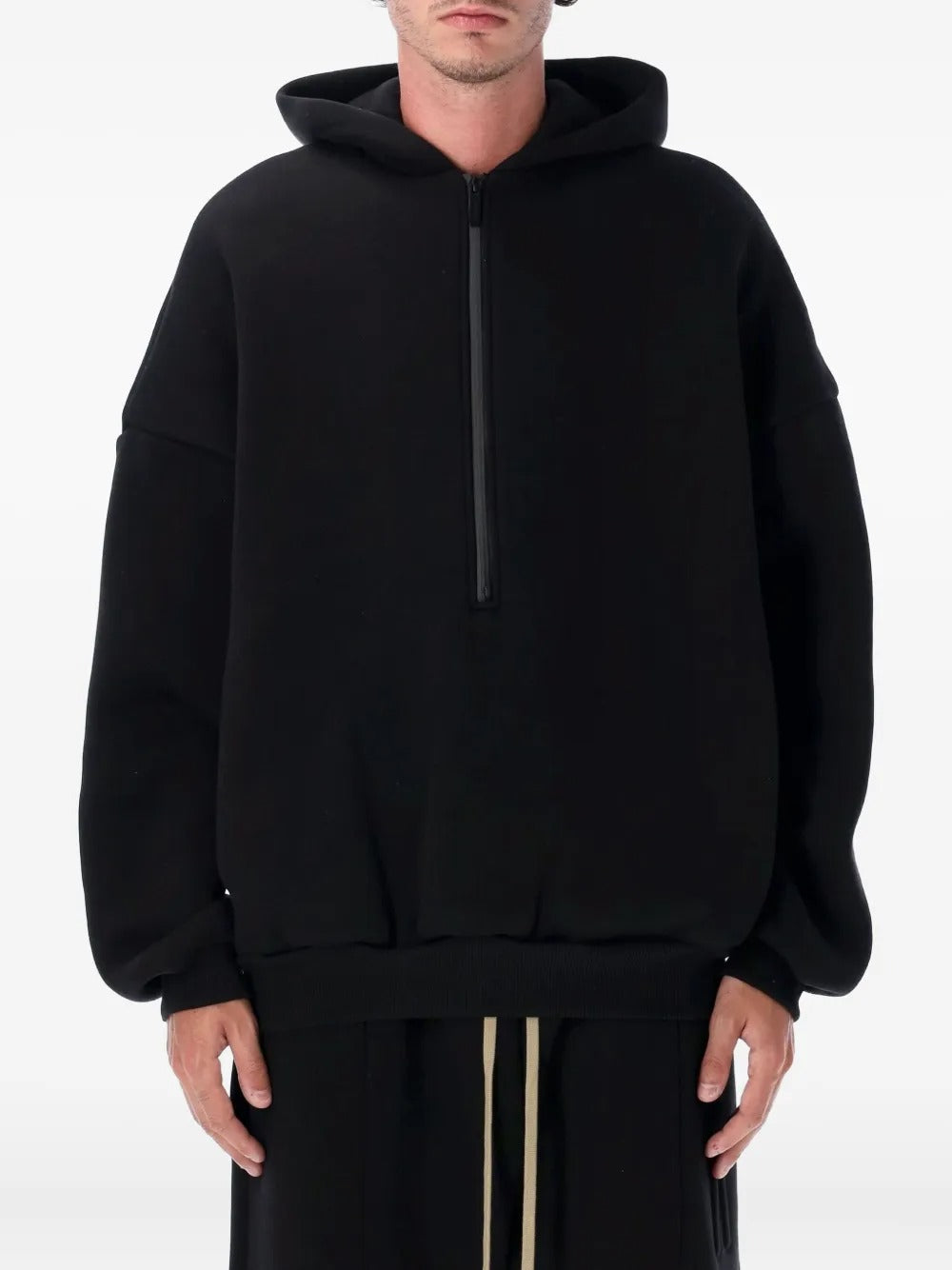 Black hoodie worn by a person, showing the hoodie's fit