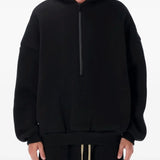 Black hoodie worn by a person, showing the hoodie's fit