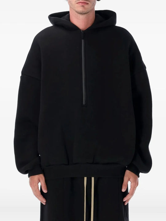Black hoodie worn by a person, showing the hoodie's fit