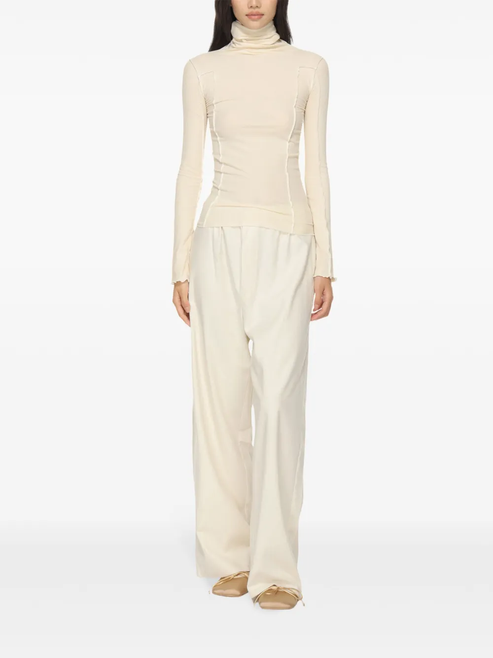 White top worn by a person, showing the top's fit