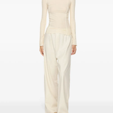 White top worn by a person, showing the top's fit