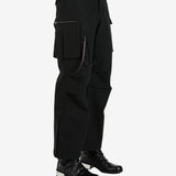 Black pants worn by a person, showing the pants's fit