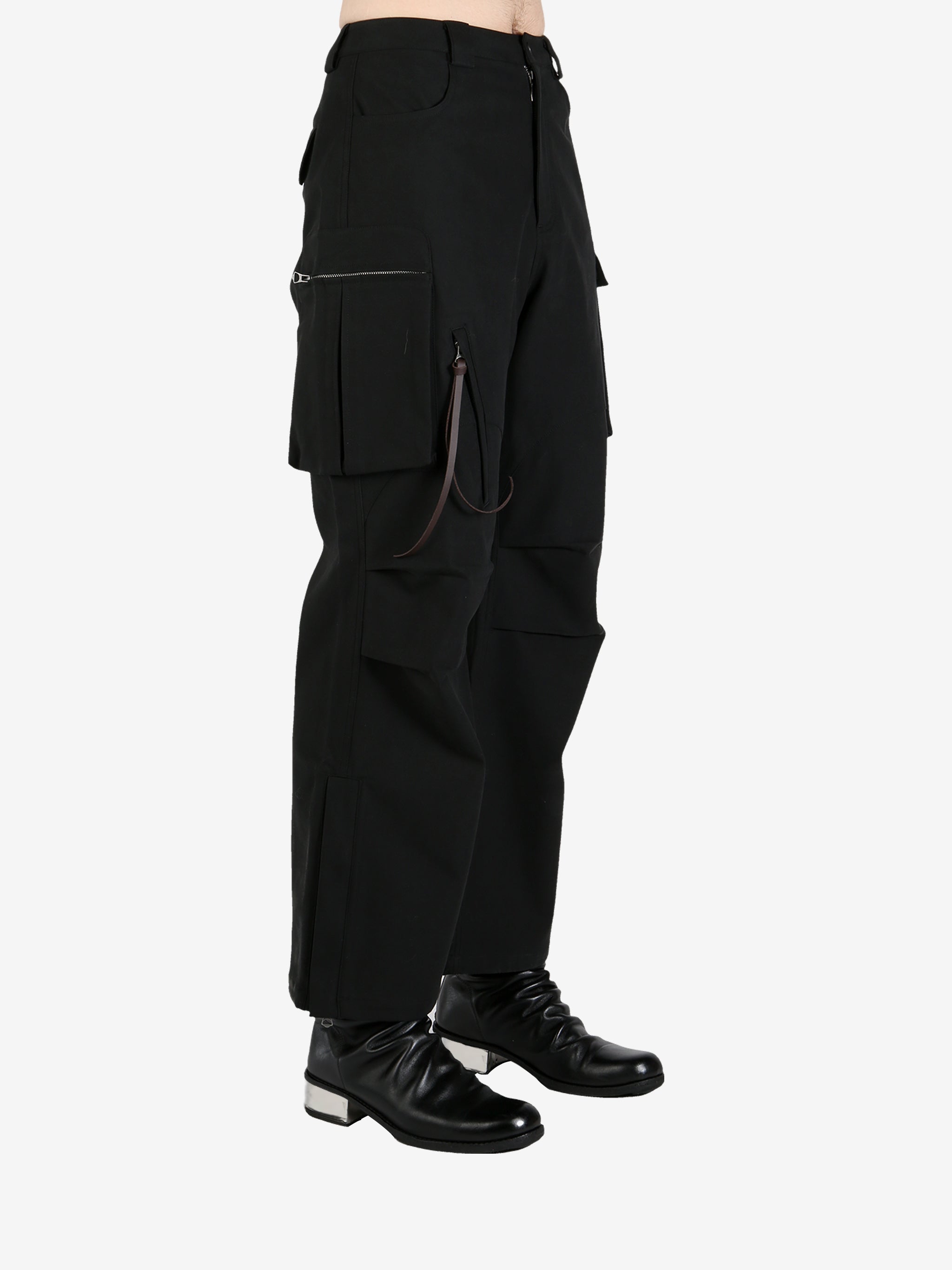 Black pants worn by a person, showing the pants's fit