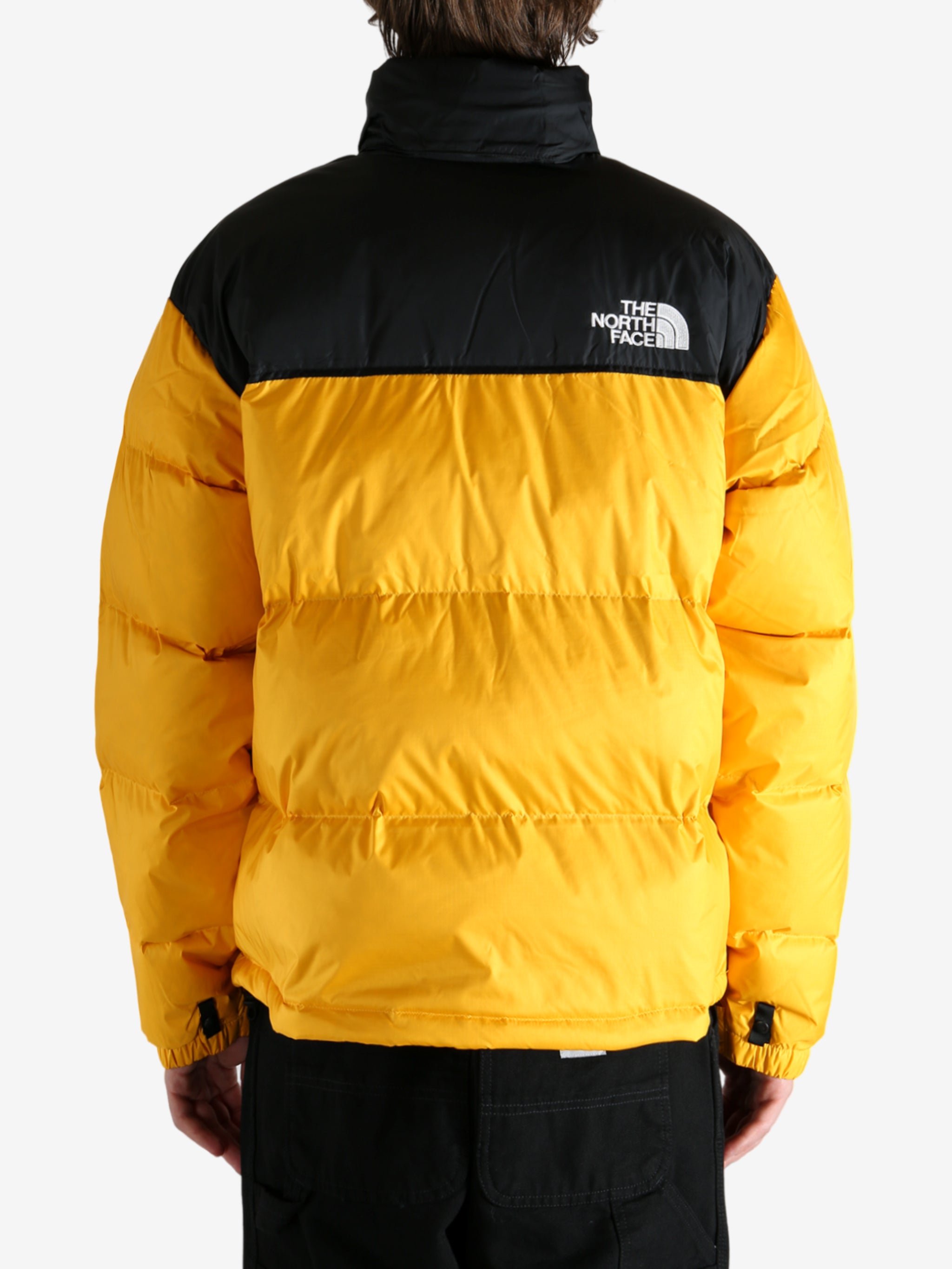 Yellow jacket worn by a person, showing the jacket's fit
