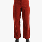 Red pants worn by a person, showing the pant's fit