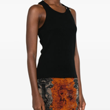 Black top worn by a person, showing the top's fit