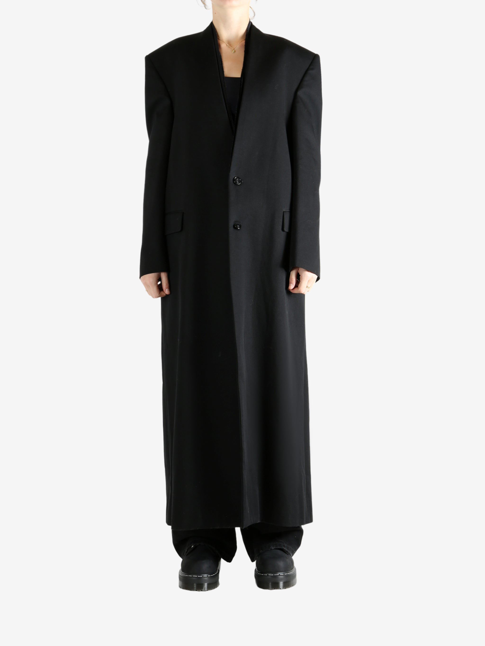 Black coats worn by a person, showing the coats fit