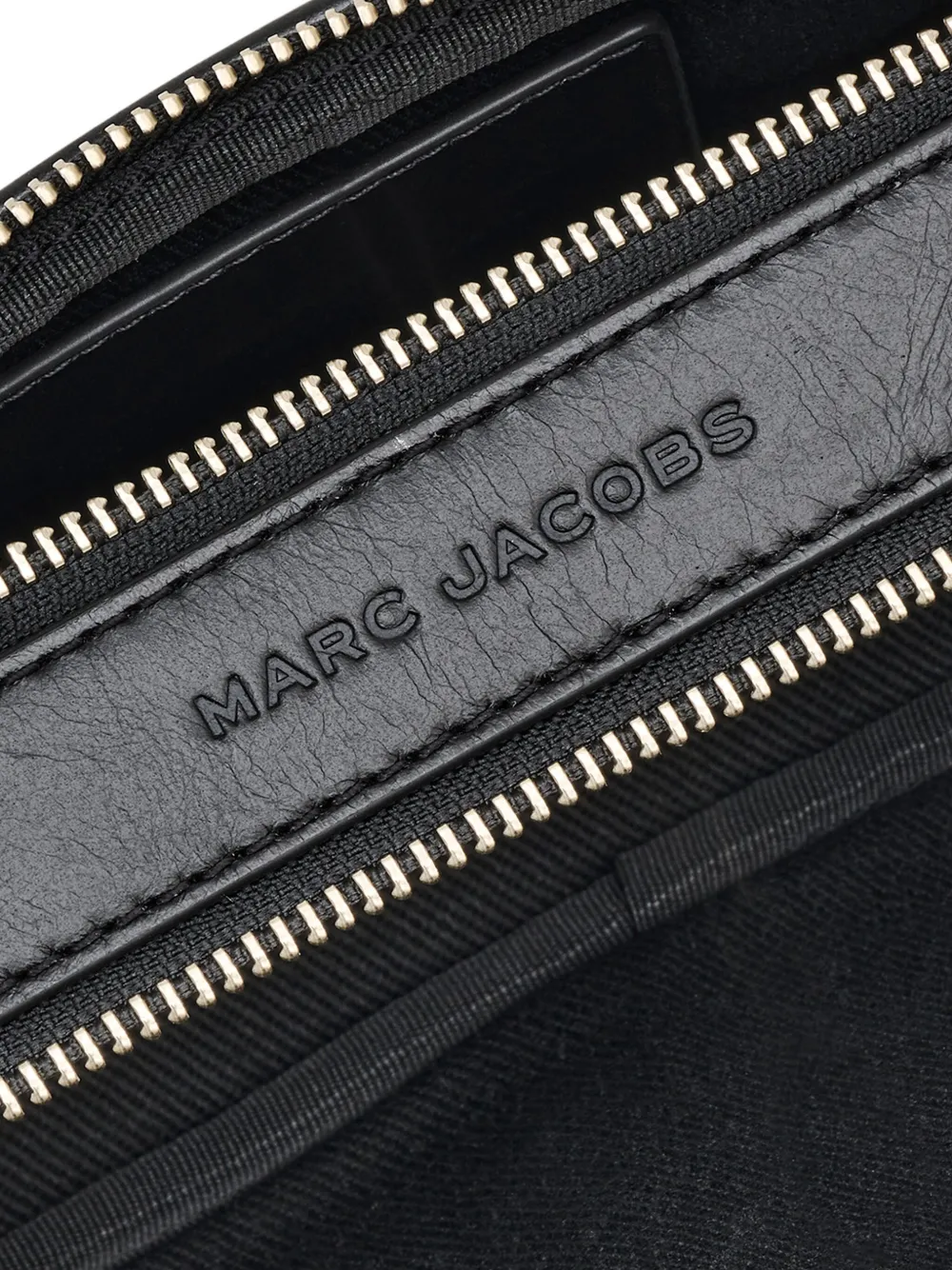 Close up of black bags, showing texture of the leather fabric