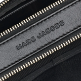 Close up of black bags, showing texture of the leather fabric