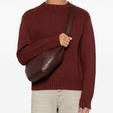 Brown bag carried by a person, showing the bag's size