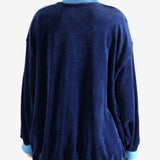 Blue jacket worn by a person, showing the jacket's fit