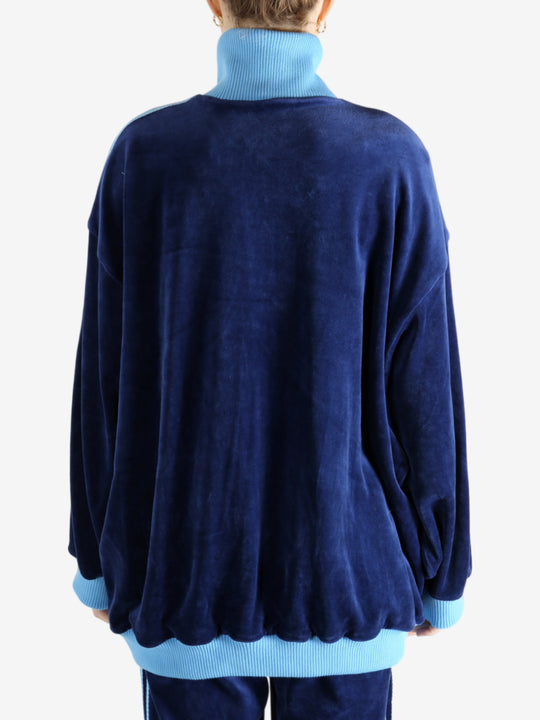 Blue jacket worn by a person, showing the jacket's fit