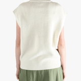 White vest worn by a person, showing the loose fit.
