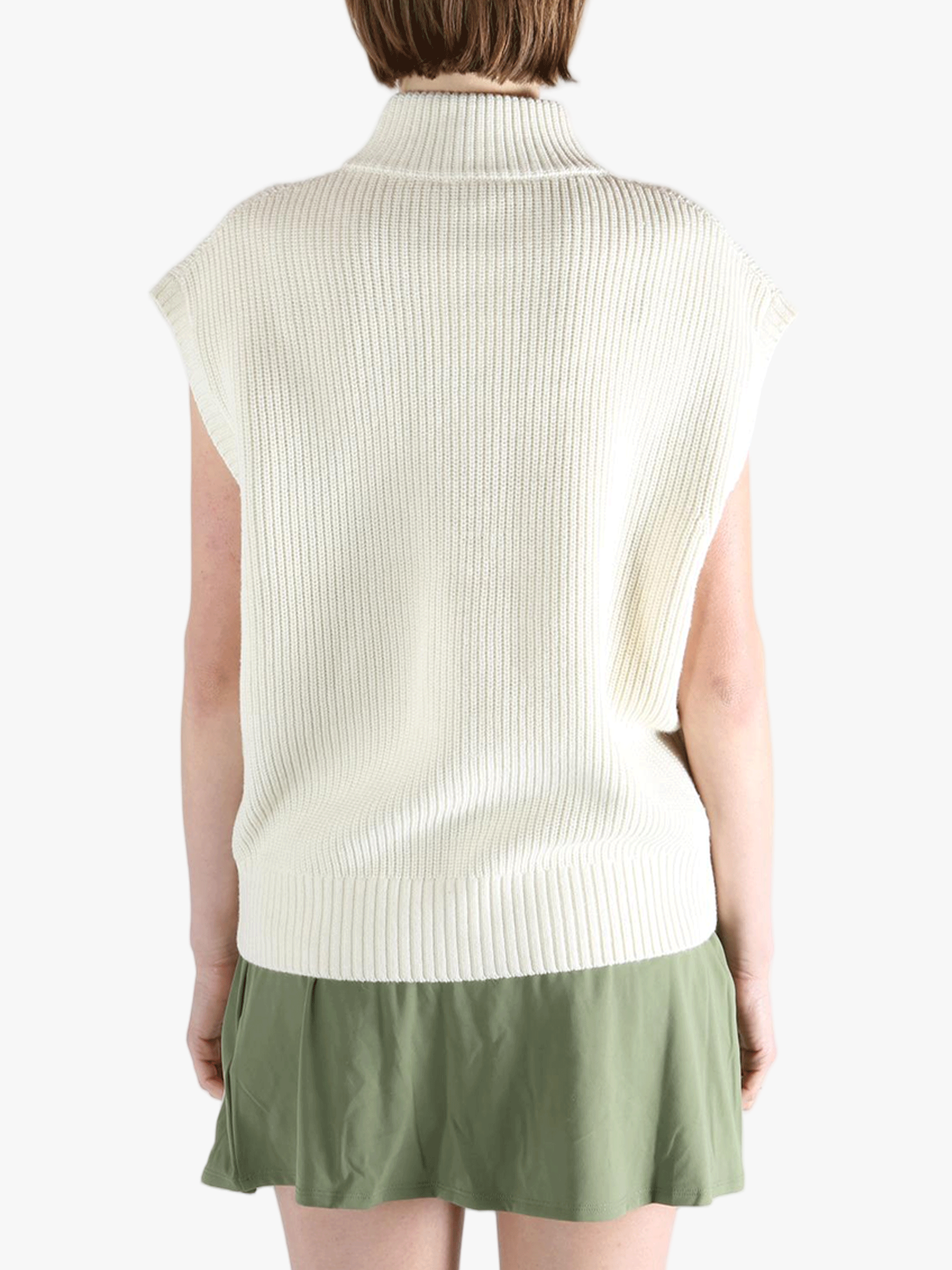 White vest worn by a person, showing the loose fit.