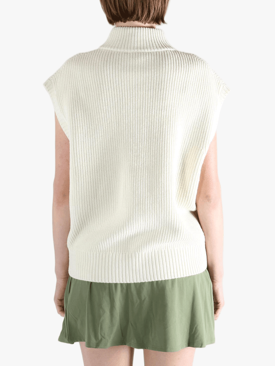White vest worn by a person, showing the loose fit.