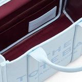 close up of blue bags, showing texture of the leather fabric