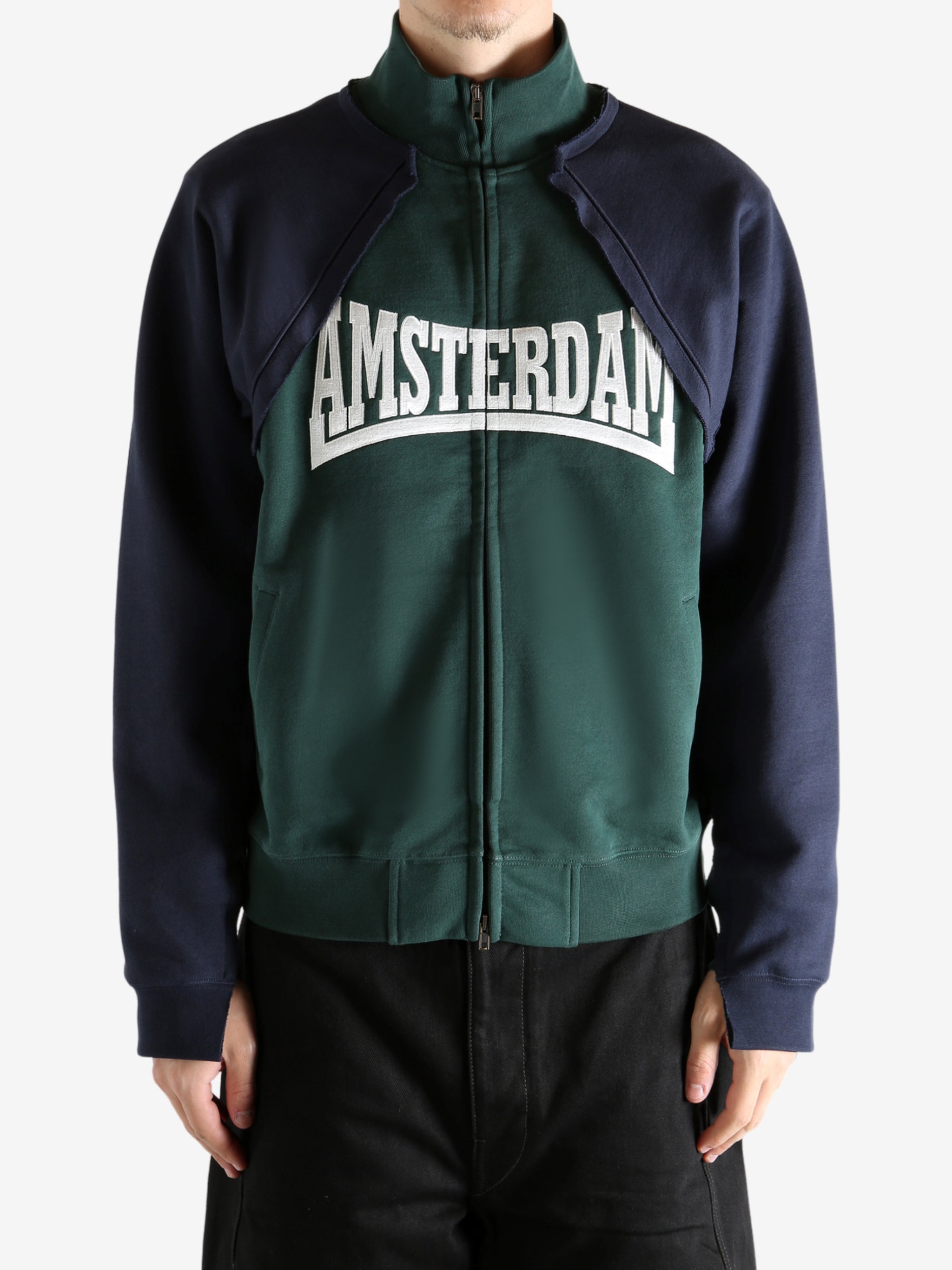 Green sweatshirt worn by a person, showing the sweatshirt's fit