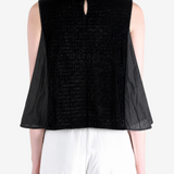 Black top worn by a person, showing the top fit