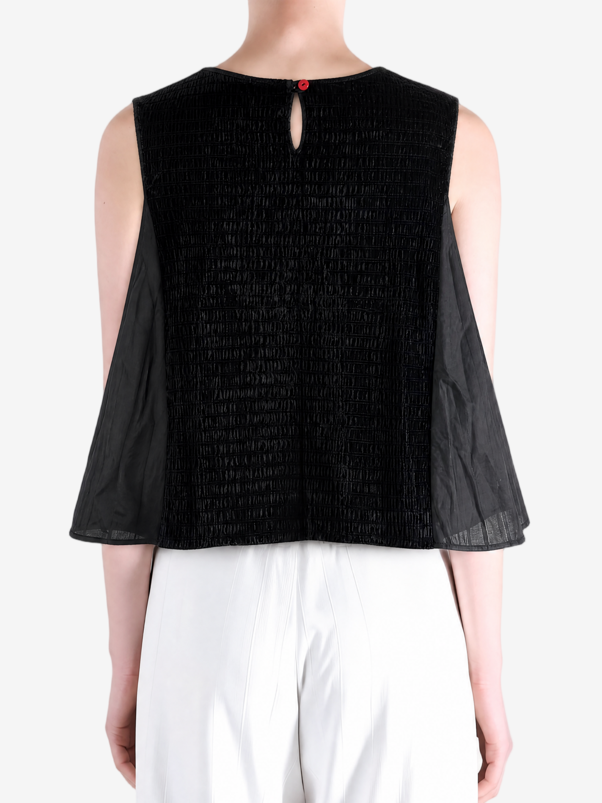 Black top worn by a person, showing the top fit