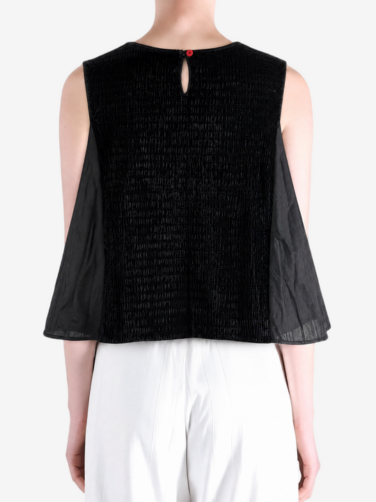 Black top worn by a person, showing the top fit