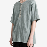 Green t-shirt worn by a person, showing the t-shirt fit