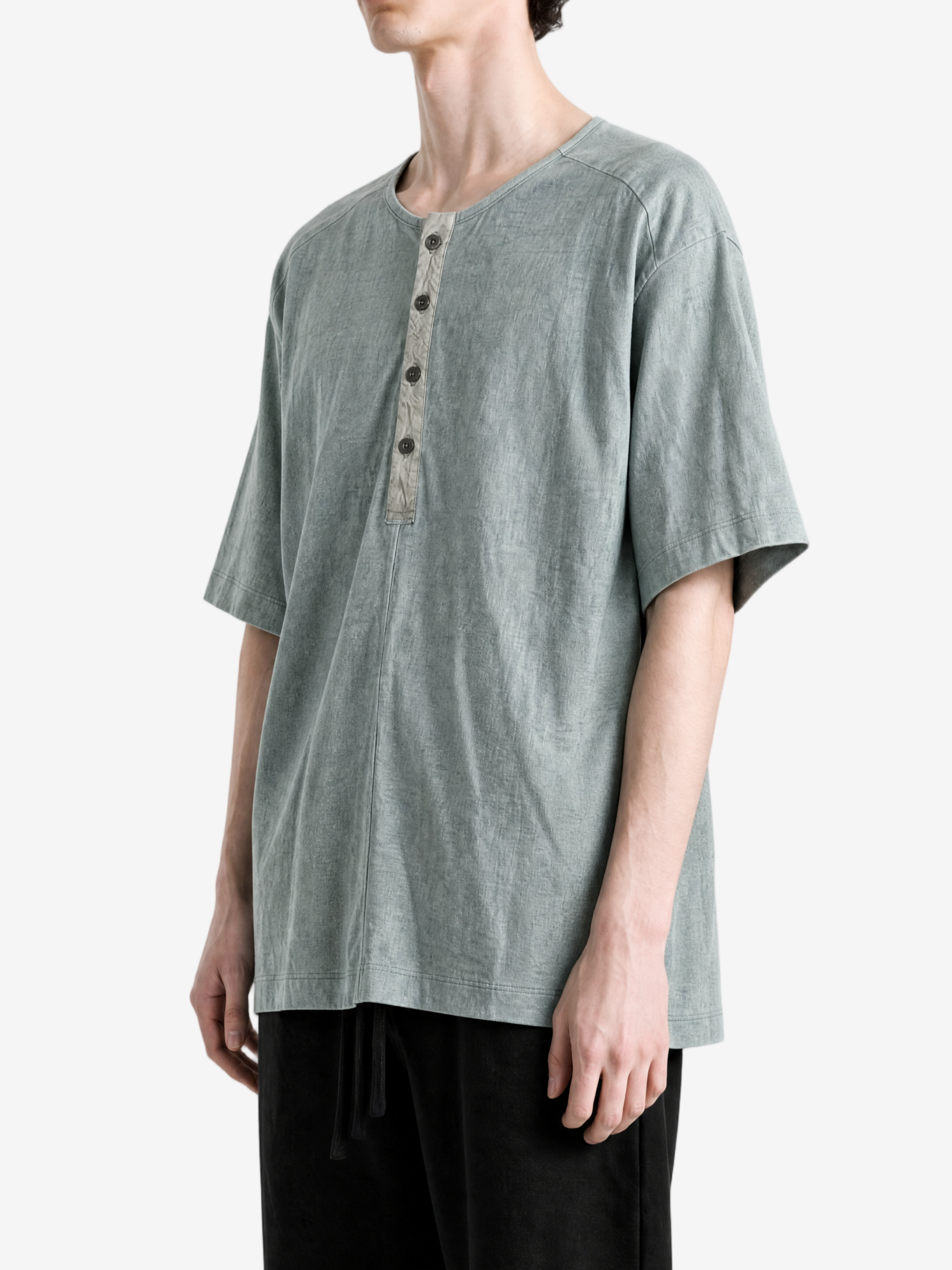 Green t-shirt worn by a person, showing the t-shirt fit