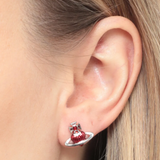 Close up of Red earrings, showing texture of the brass fabric