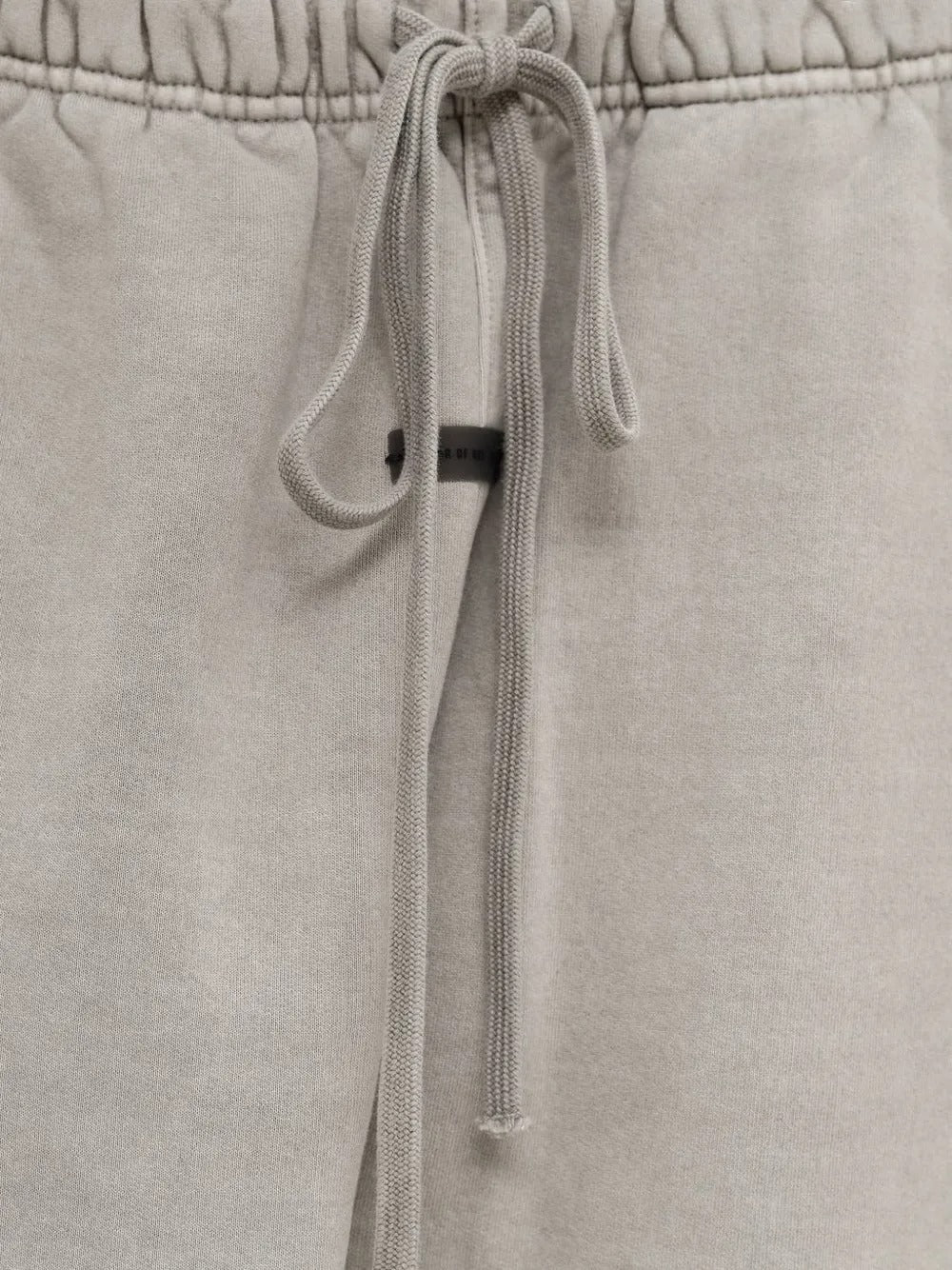 Close up of the grey pants, showing texture of the cotton fabric
