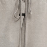 Close up of the grey pants, showing texture of the cotton fabric