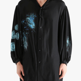 Black shirt worn by a person, showing the shirt's fit