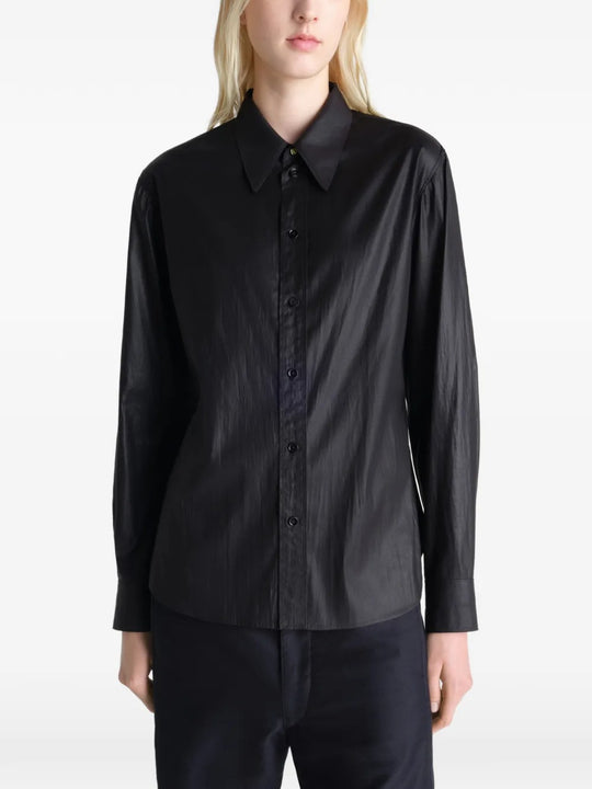 Black shirt worn by a person, showing the shirt's fit