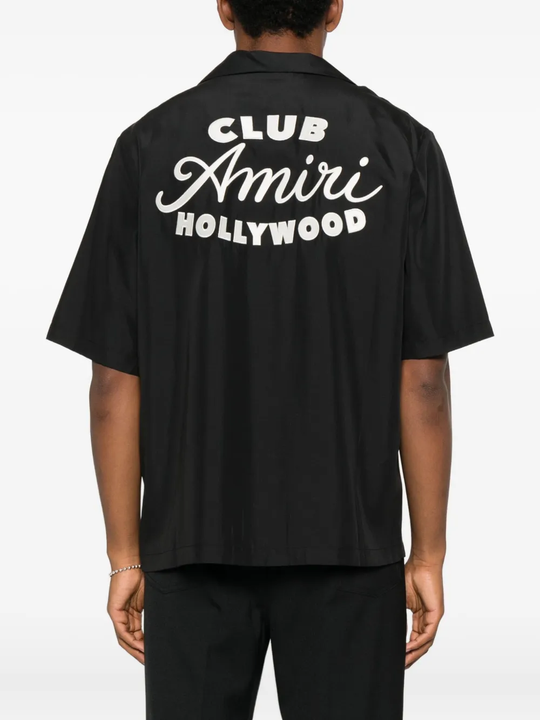 Black shirt worn by a person, showing the shirt's fit