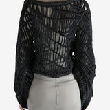 Black knitwear worn by a person, showing the knitwear fit