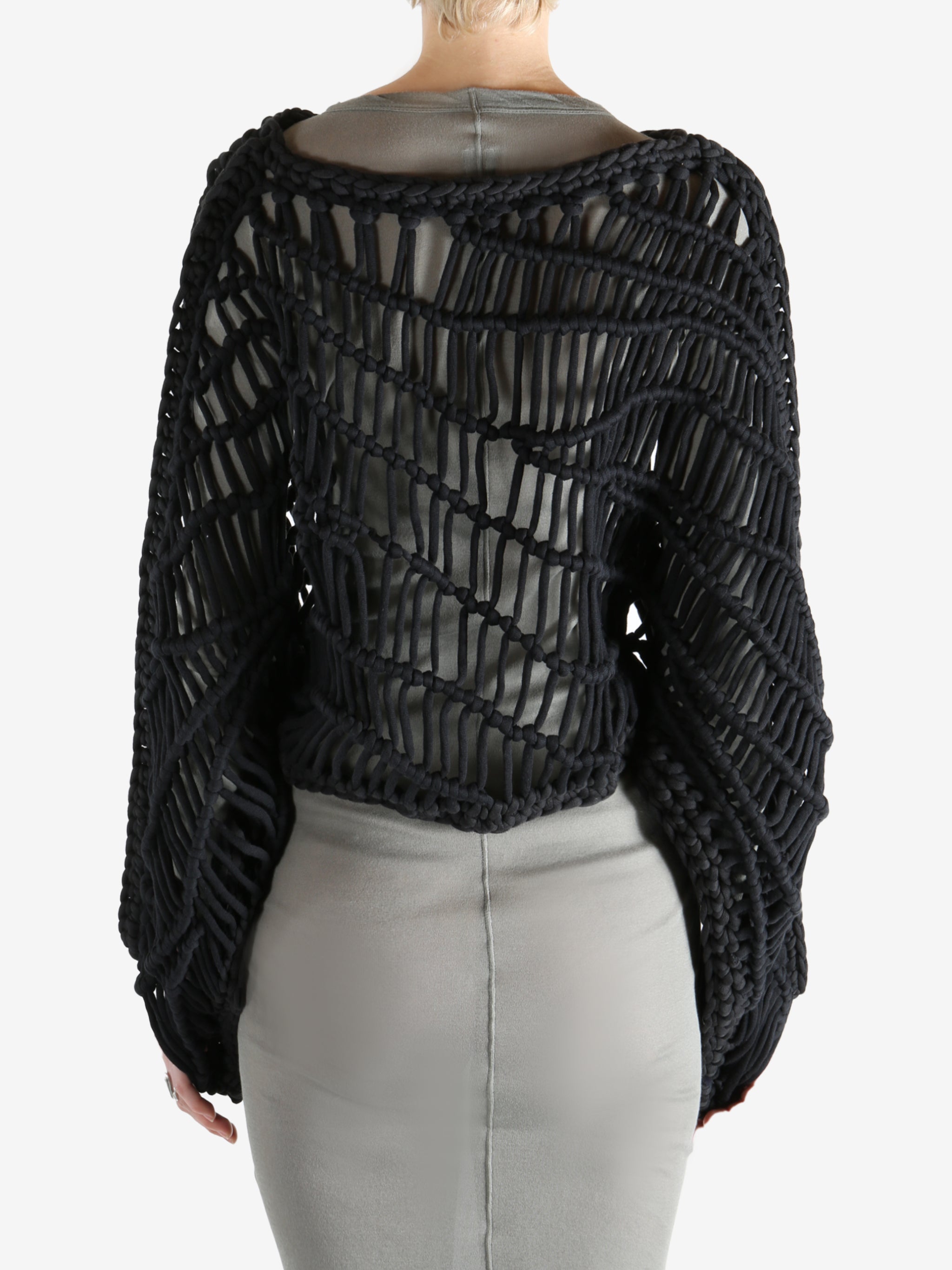 Black knitwear worn by a person, showing the knitwear fit