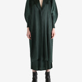 Green coat worn by a person, showing the coat's fit