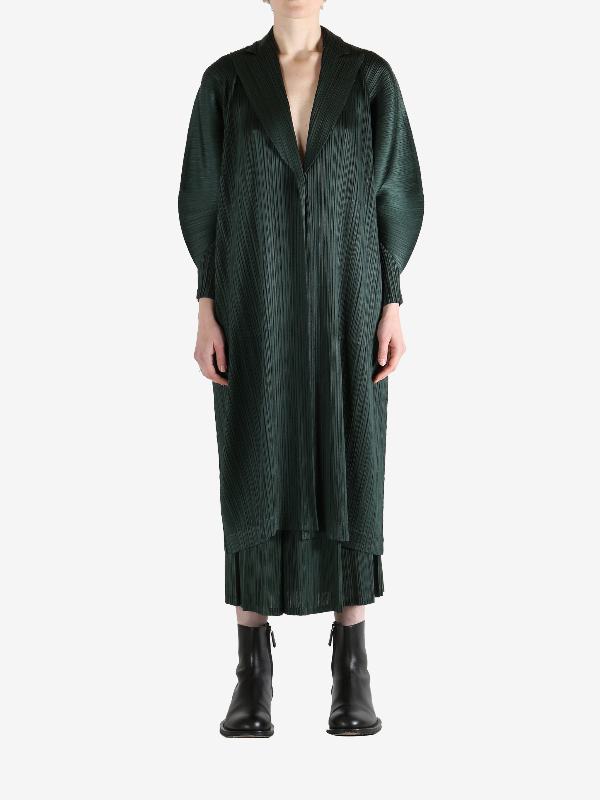 Green coat worn by a person, showing the coat's fit