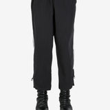 Black pants worn by a person, showing the pant’s fit