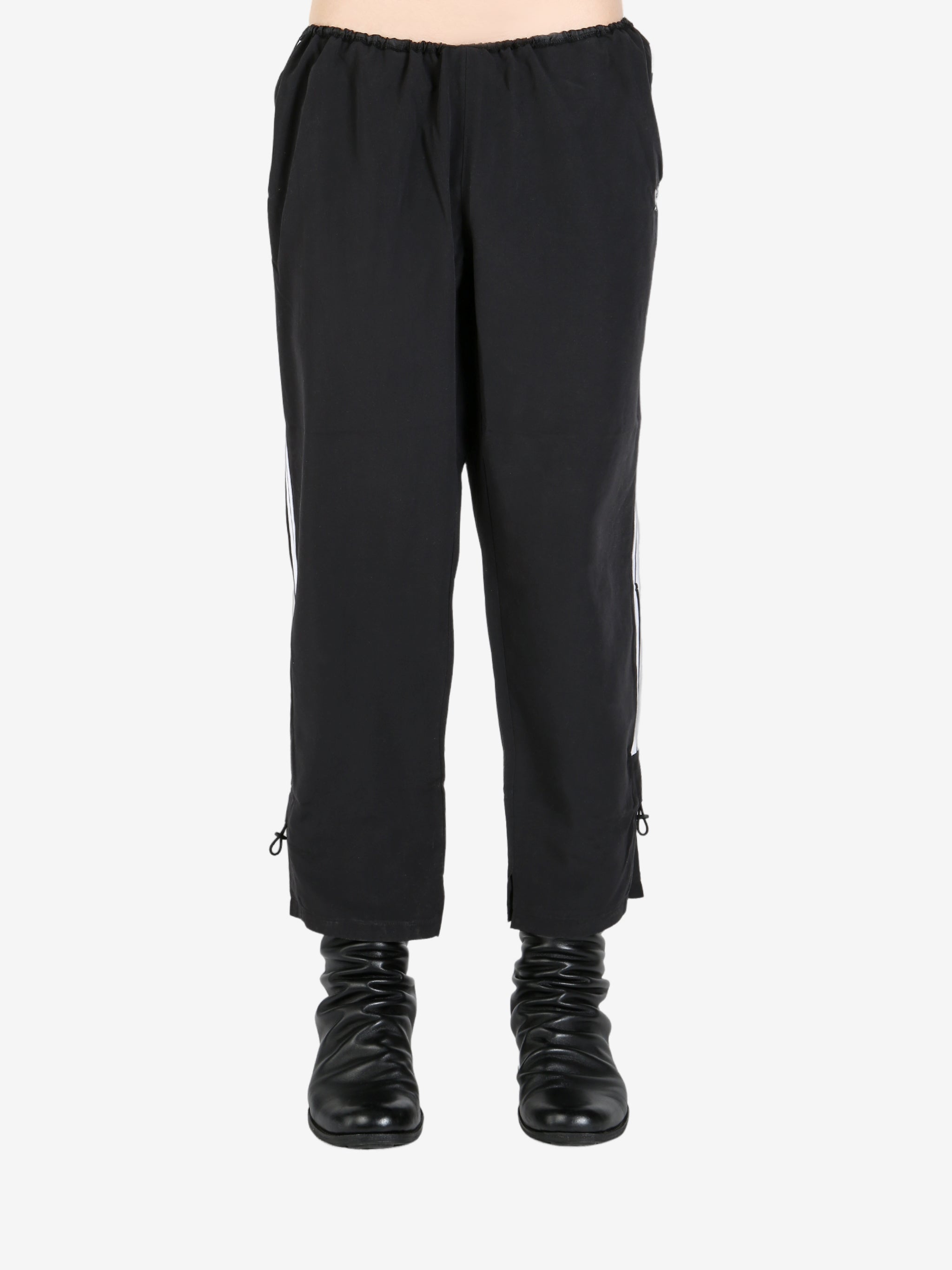 Black pants worn by a person, showing the pant’s fit