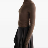 Brown top worn by a person, showing the top fit