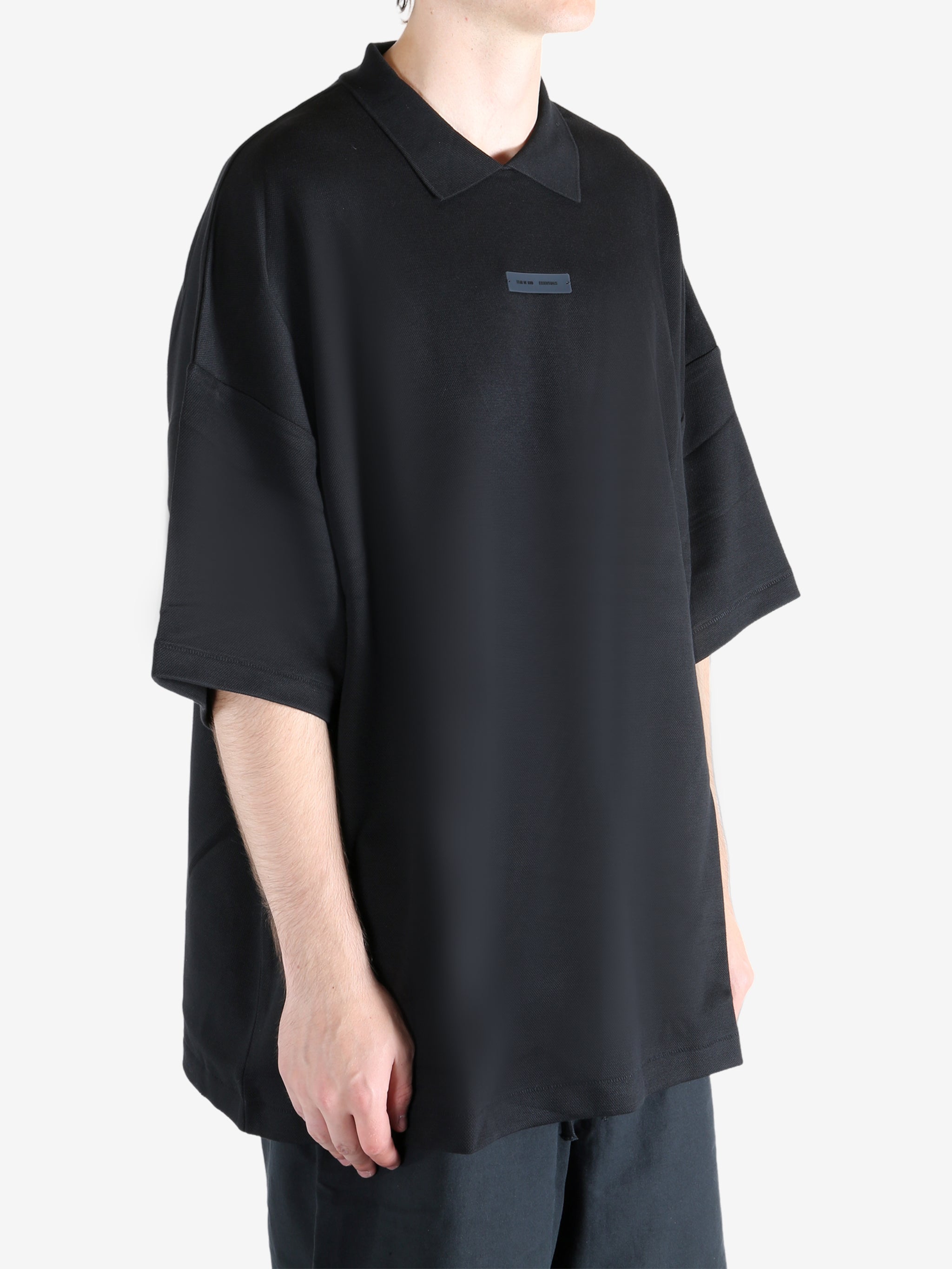 Black t-shirt worn by a person, showing the t-shirt's fit