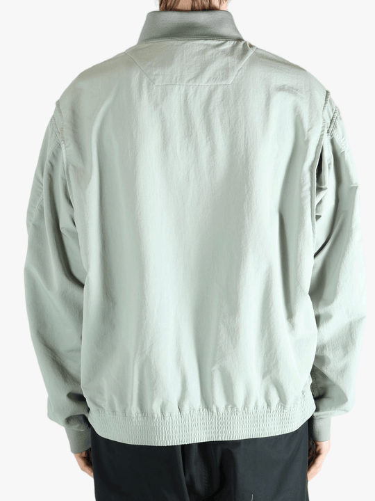 Grey jacket worn by a person, showing the jacket's fit