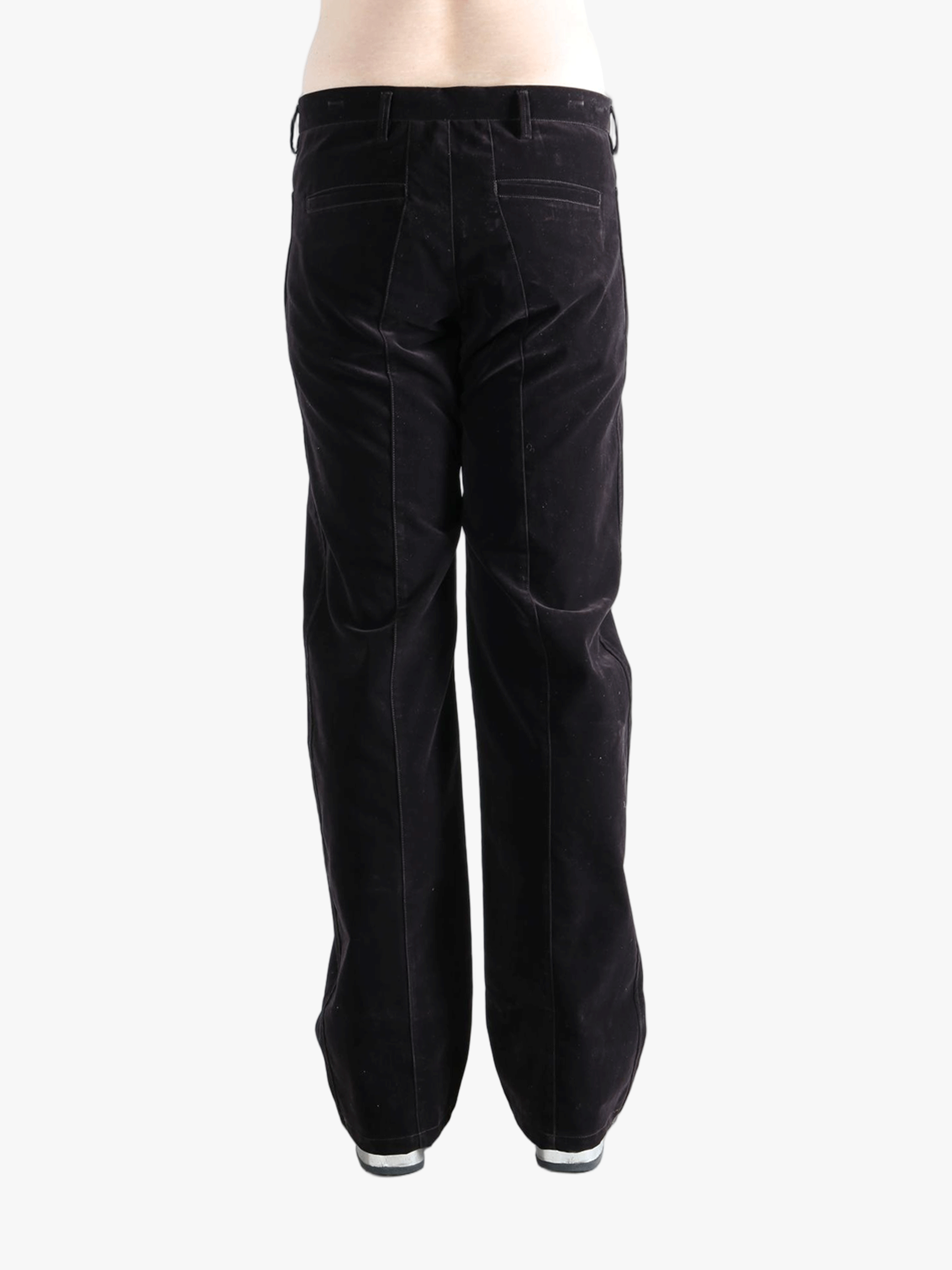 Black pants worn by a person, showing the pants  fit