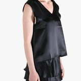 Black top worn by a person, showing the top's fit