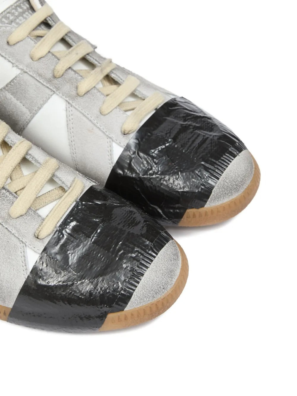 Close up of white sneakers, showing texture of the leather and rubber and polyethylene and cotton fabric