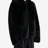 Black jacket worn by a person, showing the jacket fit